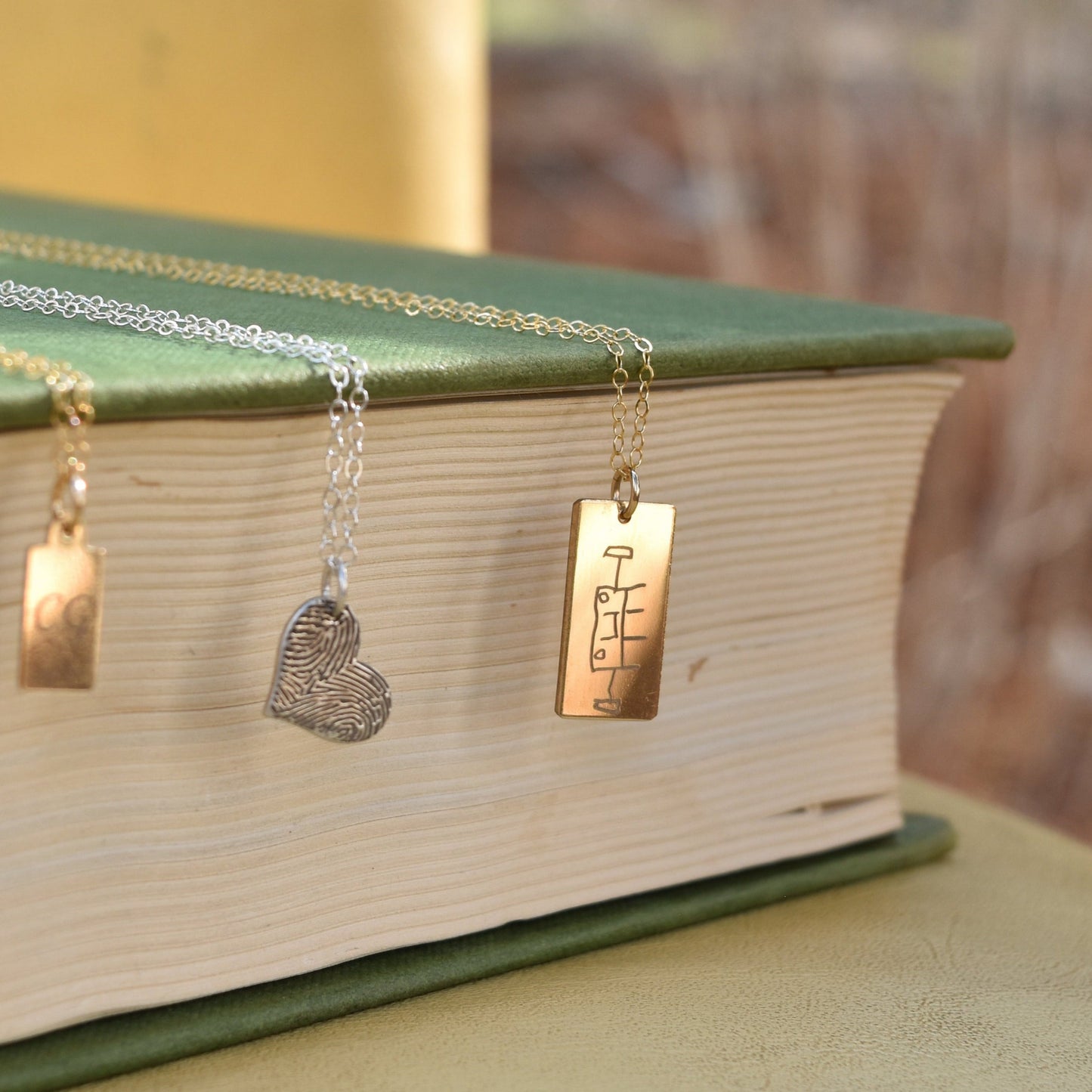 Child's doodles engraved on a gold-filled necklace pendant. April Child personalised engraved jewellery