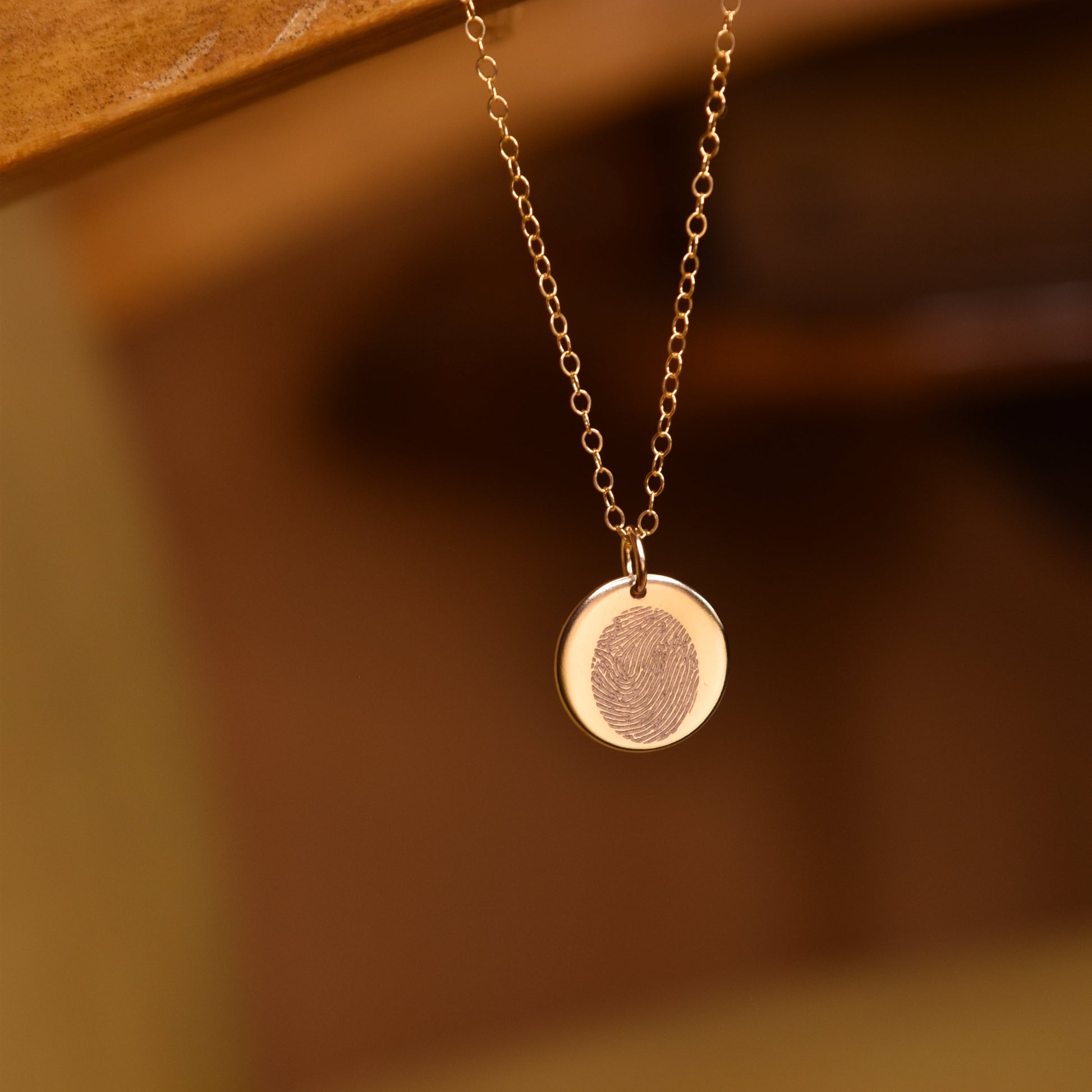 fingerprint engraved on a gold necklace- april child- personalised engraving