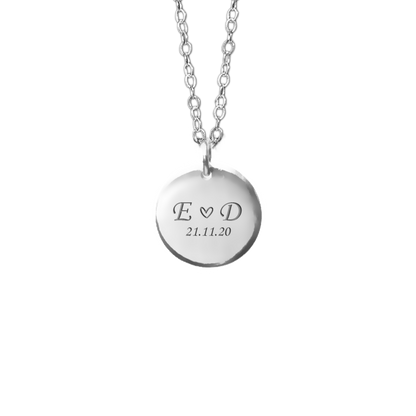 Silver necklace with a round pendant engraved with your name initials and a date. Keepsake jewellery. April Child